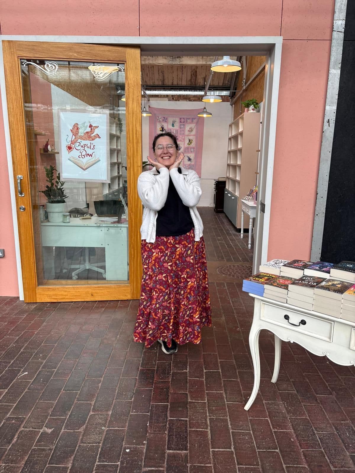 The owner of Cupid's Bow Books standing in the shop doorway